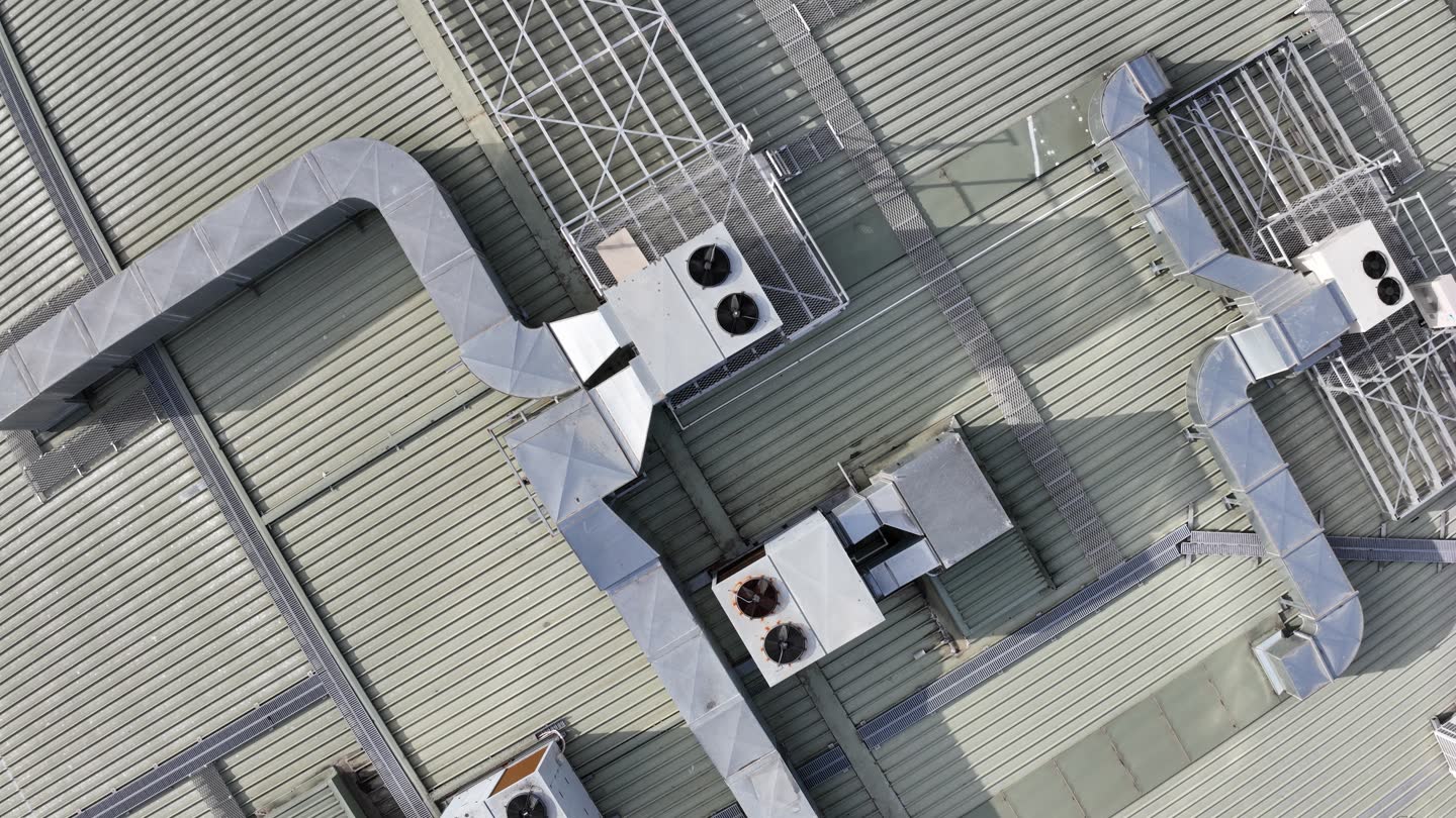 Example: close aerial view of the top of a silo and conveyor
