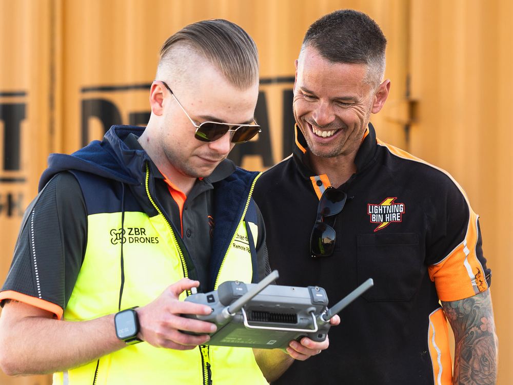 Zak showing a client the live drone feed on the controller
